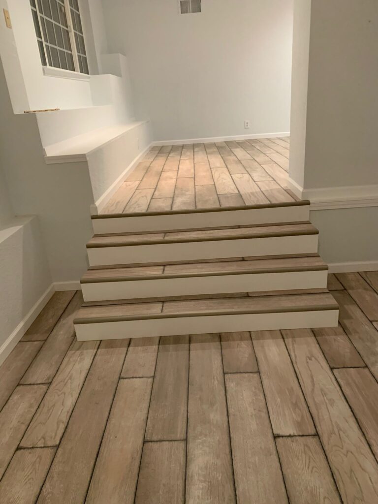 Finished flooring installation by Pablo General Contractor in Oakland, showcasing high-quality hardwood and tile craftsmanship.