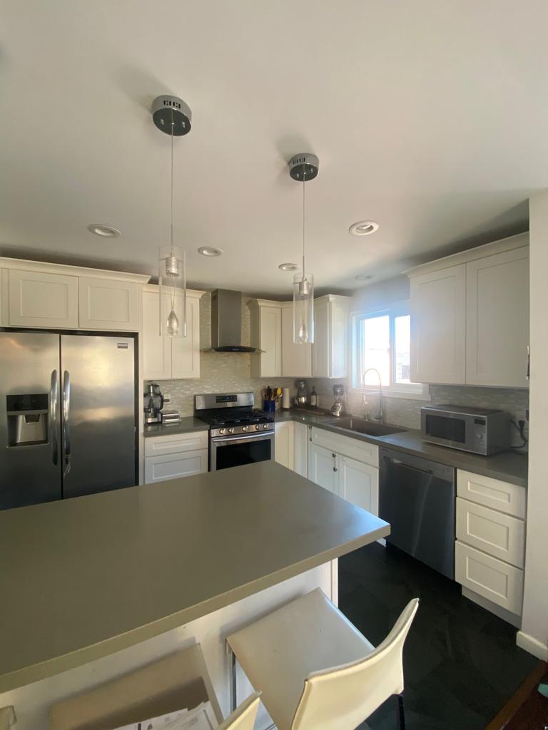 Custom kitchen remodel with modern cabinets, countertops, and lighting in Oakland, CA